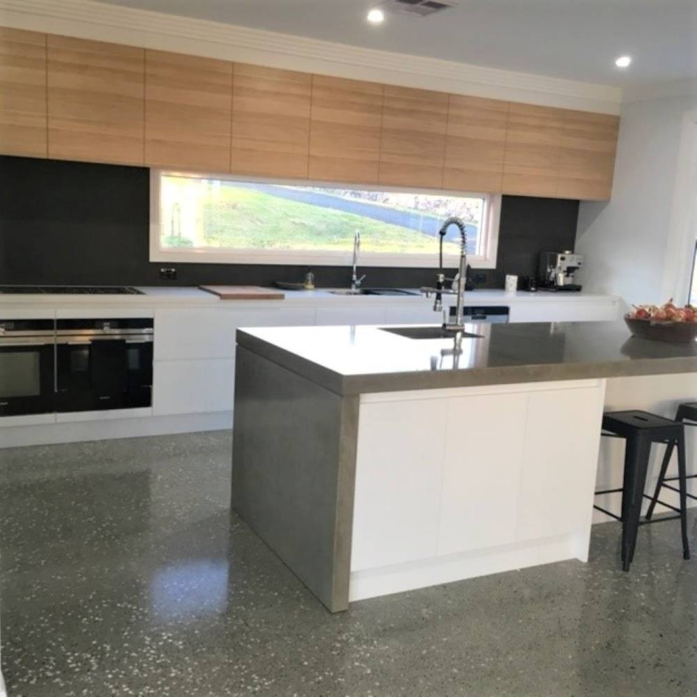 Highland Kitchens - Modern Concrete kitchen with detailed windowed backsplash